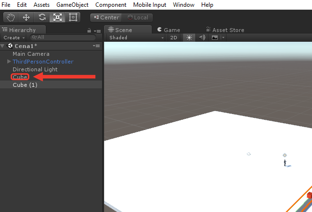 Painel Hierarchy do Unity com a Main Camera, o ThirdPersonController, a Directional Light, o Cube e o Cube (1), que está selecionado com fundo cinza. Uma moldura e uma seta vermelhas destacam o Cube